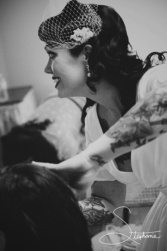 A bride helping her daughter style her hair. 