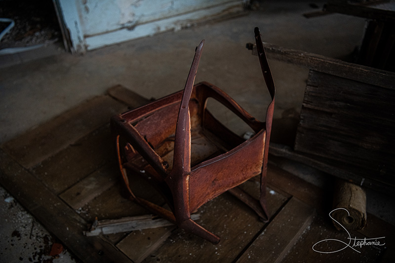 Photo of an abandoned child's chair in an empty house.