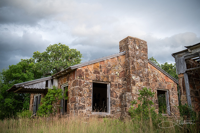 Photo of an abandoned building in the middle of a field.