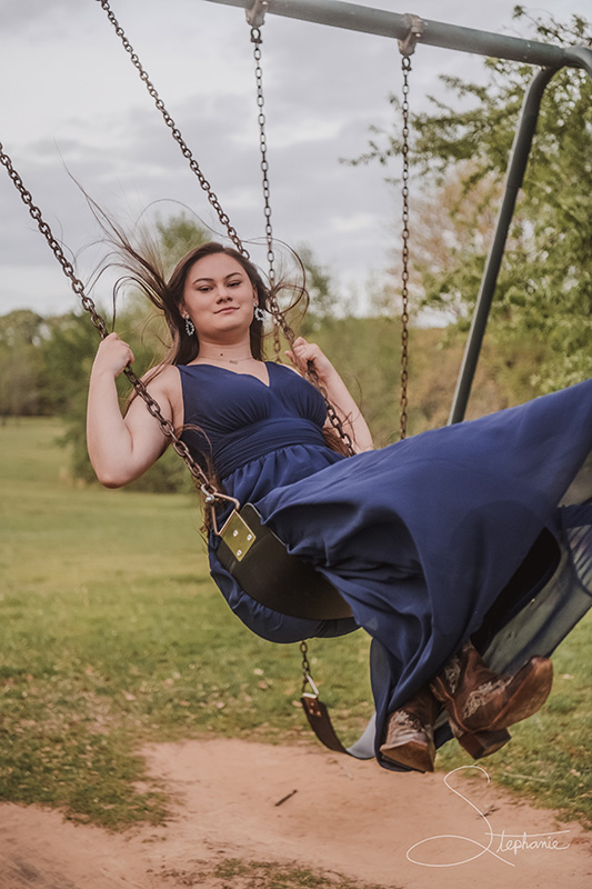 Photo of a girl on a swing.